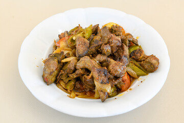 Turkish and Arabic Traditional Ramadan doner kebab with tasty tomato sauce and rice or turkish pilav in white plate on wood table background. ( Pilav ustu doner)
