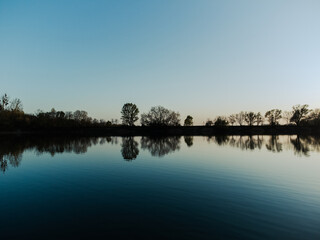 Bird's eye view of the lake and forest. Spring nature. View from a drone