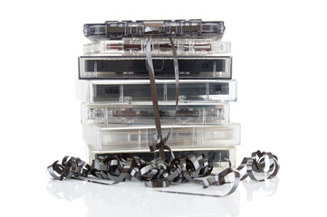 Stack of old vintage audio cassettes close up isolated on white background