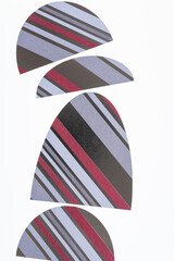scrapbook paper machine cut shapes (mostly ovoids) on a light background - silver, red, and white stripes