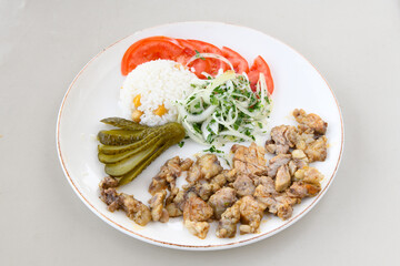 Turkish and Arabic Traditional Ramadan doner kebab with tasty tomato sauce and rice or turkish pilav in white plate on wood table background. ( Pilav ustu doner)