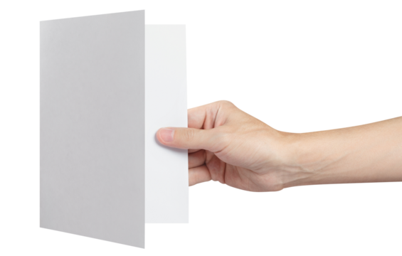 Hand holding a sheet of white paper, folded in half, cut out