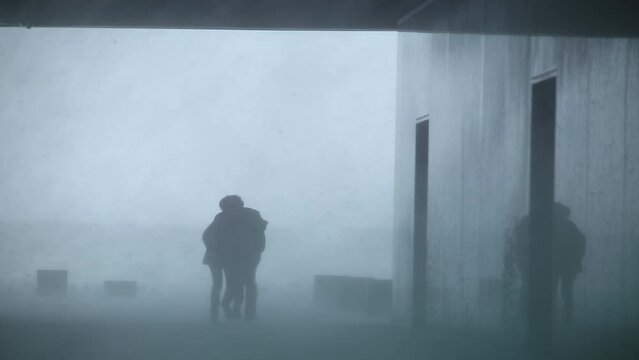 People struggling to get inside during a heavy blizzard, Reykjavik, Iceland