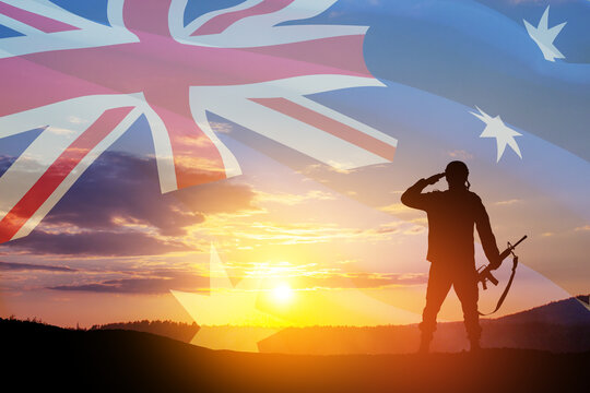Silhouette of soldier saluting on background of Australia flag and the sunset or the sunrise background. Anzac Day. Remembrance Day.