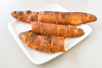 Turkish style meat stuffed filo dough borek served kol boregi. Cheese and minced pie are sliced on a marble background. Turkish name: Kol Boregi, ispanakli, kiymali, Su Boregi