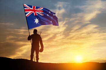 Silhouette of soldier with Australia flag on background of the sunset or the sunrise background....