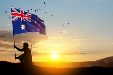 Silhouette of soldier with Australia flag on background of the sunset or the sunrise background. Anzac Day. Remembrance Day.