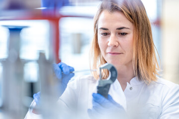 measurement of material for research by a young woman in a scientific laboratory