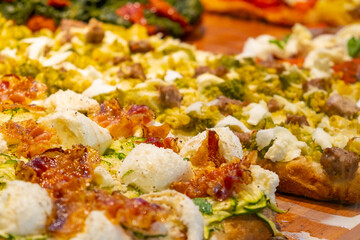 Pizza topped with a generous amount of melted cheese and crispy bacon.