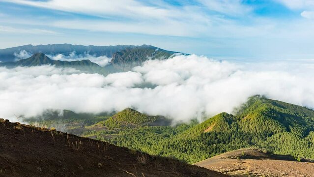 Zooming timelapse sequence of tradewind clouds moving against the mountains of La Palma between the Caldera de Taburiente in the background and the Cumbre Vieja. Seen from the top of the volcano Birig