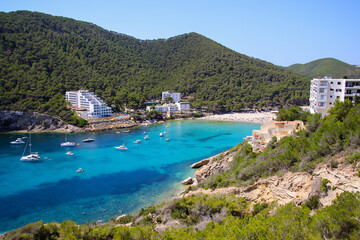 Cala Llonga bay on the southern side of Ibiza in the Balearic islands in the Mediterranean Sea - Cove with turquoise waters surrounded with pine covered hills