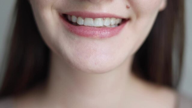 A young girl uses aligners to straighten her teeth