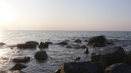 Fototapeta na wymiar a beautiful sunrise over the sea. foreground stone backgrounds