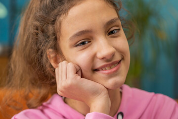 Close-up portrait of happy calm beautiful preteen school girl smiling friendly, glad expression...