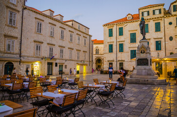 Fototapeta na wymiar Cozy street and old city walls at night in Dubrovnik, Croatia