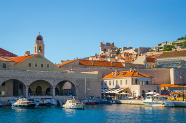 Sunset panoramic view on walls and port of famous old city Dubrovnik, Croatia