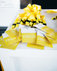 yellow lanyards press badges on white table