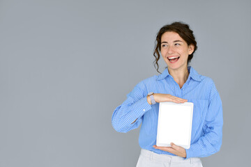 Happy smiling business woman holding digital tablet computer showing blank empty mock up screen...