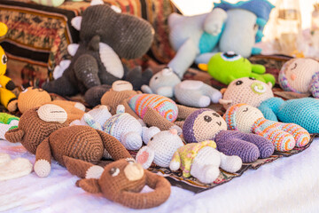 Fototapeta na wymiar Amigurumi (crocheted or knitted stuffed toy) in a fair stall.
