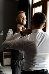 Groom's portrait. The groom is preparing to meet the bride. Photo session of a successful businessman.