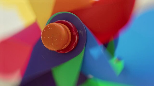 Wind blowing softly, a pinwheel spins on a sandy beach. Joy of travel, exploration, and the pursuit of happiness and fulfillment.