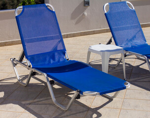Two blue sun loungers in a hotel near the hotel