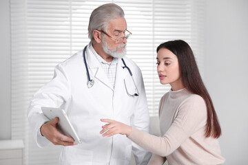 Fototapeta premium Patient having appointment with senior doctor in clinic