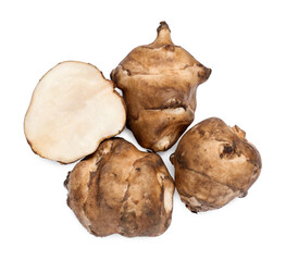 Whole and cut Jerusalem artichokes isolated on white, top view
