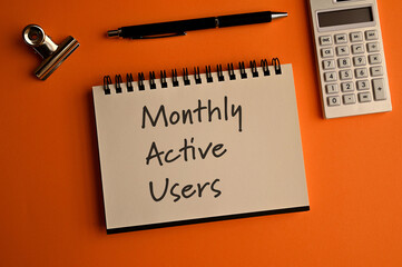 There is notebook with the word Monthly Active Users.It is as an eye-catching image.