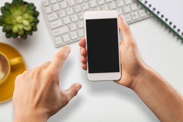 Hand holding a modern smartphone with blank screen