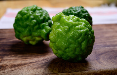 kaffir lime or makrut lime, citrus fruit native to tropical Southeast Asia. Fruit and leaves used in Southeast Asian cuisine, essential oil is used in perfumery for intense citrus fragrance.