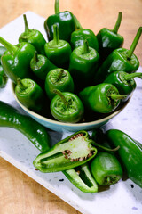 Fresh green mild padron pepper pementos, ready for grill or to be fried with olive oil, traditional snack in Galicia, Spain