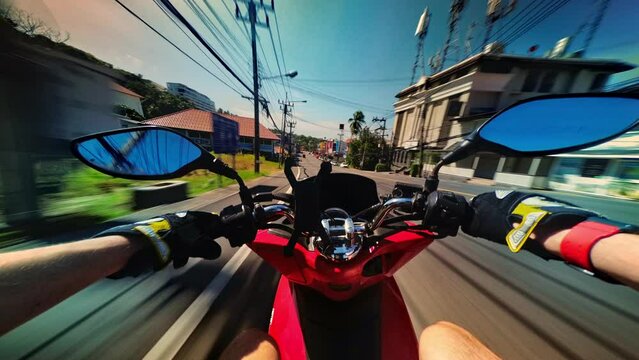 Man is driving motorcycle at hot summer day in tropical asian country filmed in timelapse and stop motion. Pov of male holiday maker exploring city on rental scooter on summer holidays. Travel theme