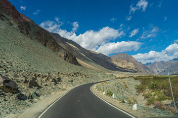 beautiful photo of the road going through the mountains and blue sky at Turtuk village, Nubra Valley, Ladakh, India.