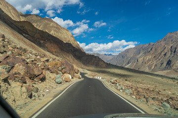 road with two sides are high mountains, and blue sky. Beautiful scenery on the way to Turturk Villgae, Leh, Ladakh, Jammu and Kashmir, India