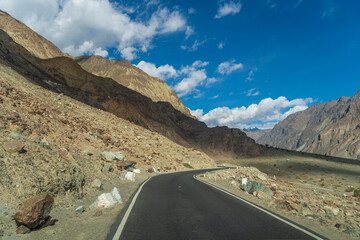 beautiful photo of the road going through the mountains and blue sky at Turtuk village, Nubra Valley, Ladakh, India.