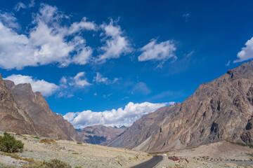 road with two sides are high mountains, and blue sky. Beautiful scenery on the way to Turturk Villgae, Leh, Ladakh, Jammu and Kashmir, India