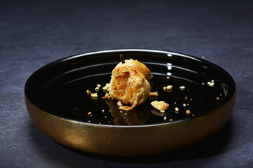 mini bake luxury tart in Japanese hojicha crisp with cranberry pineapple jam paste inside with clove stick and black plate gold fork knife on dark background pastry dessert halal party food menu