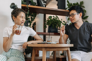 Sweet asian couple lover flirting date in the cafe.