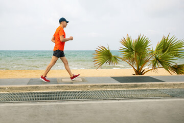 man running on seaside promenade. concept of healthy living.