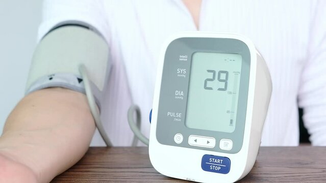 Title	
Man checks blood pressure monitor and heart rate monitor with digital pressure gauge. Health care and Medical concept.	
