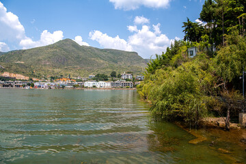 Erhai Lake and Nanzhao Folk Island (Nanzhao Customs Island), located in Dali, Yunnan, China. Blue sky with clouds, copy space for text