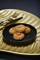 handmade baked luxury almond cashew nut butter quqi cookies and gold leaf plate fork knife on dark background pastry cafe dessert halal vegan party restaurant food gluten free menu
