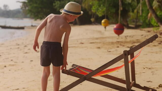 Boy Walking Towards The Sun Lounger
