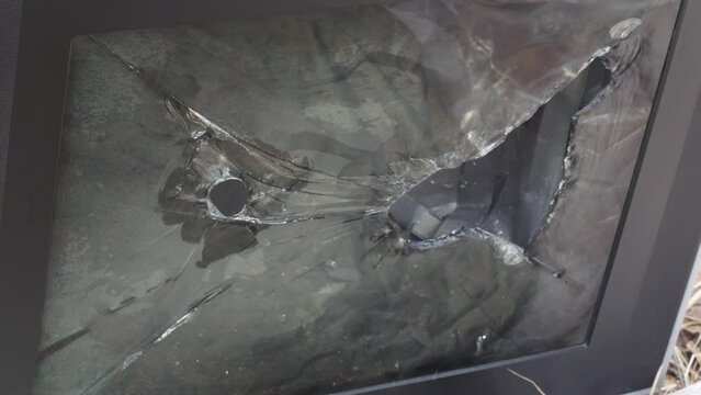 a sledgehammer breaks the screen of a kinescope of an old tv. selective focus. hammer blows on the tv screen