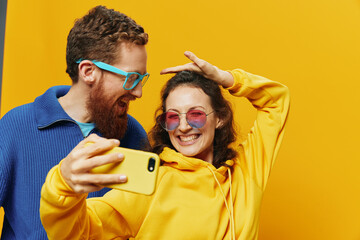 Woman and man funny couple with phones hand social networking and communication crooked do selfies...