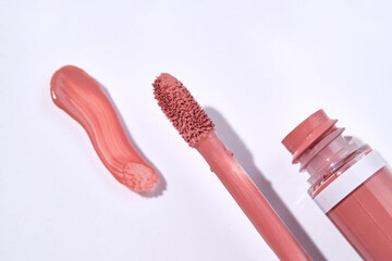 Red lip gloss with applicator and smear. - obrazy, fototapety, plakaty