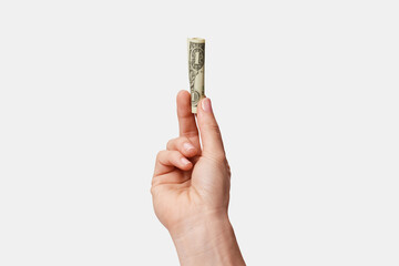 woman's hand with rolled dollar isolated on white background