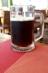 Glass of stout on table