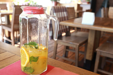 Pitcher with lemonade on table